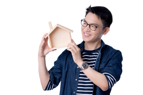 Business Insurance Communication Ideas Concept With Asian Attractive Male Casual Tshirt Hand Hold Wooden House Model Box Smile Happiness Hand Gesture Pose Pr Min